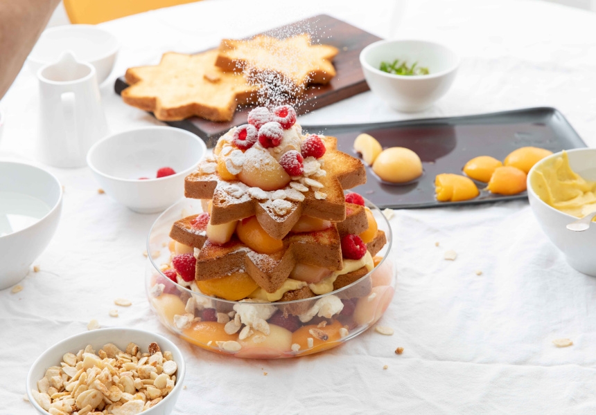 Finish with fresh raspberries, almonds (if using) and a dusting of icing sugar. Garnish with fresh verbena leaves and serve. 
